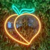 Peach emoji neon sign